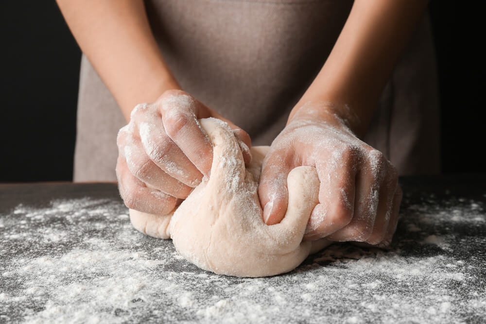 Female Hands Making Dough for Pizza