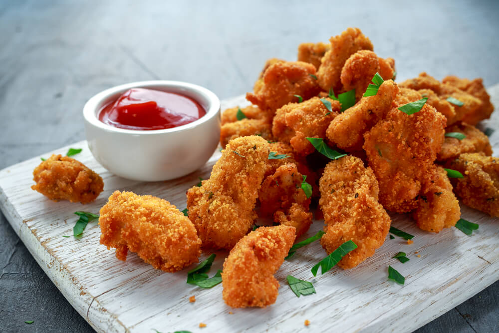 Fried Crispy Chicken Nuggets With Ketchup on White Board