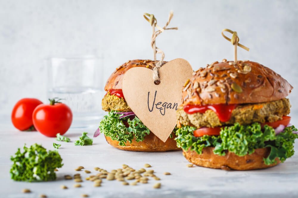 Vegan Lentil Burgers With Kale and Tomato Sauce on a White Background