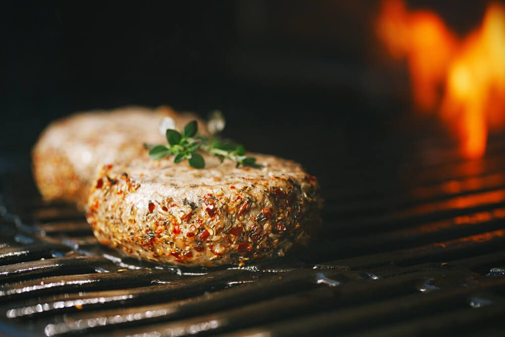 lamb burgers spiced by mint and lamb rub on bbq grill with flame