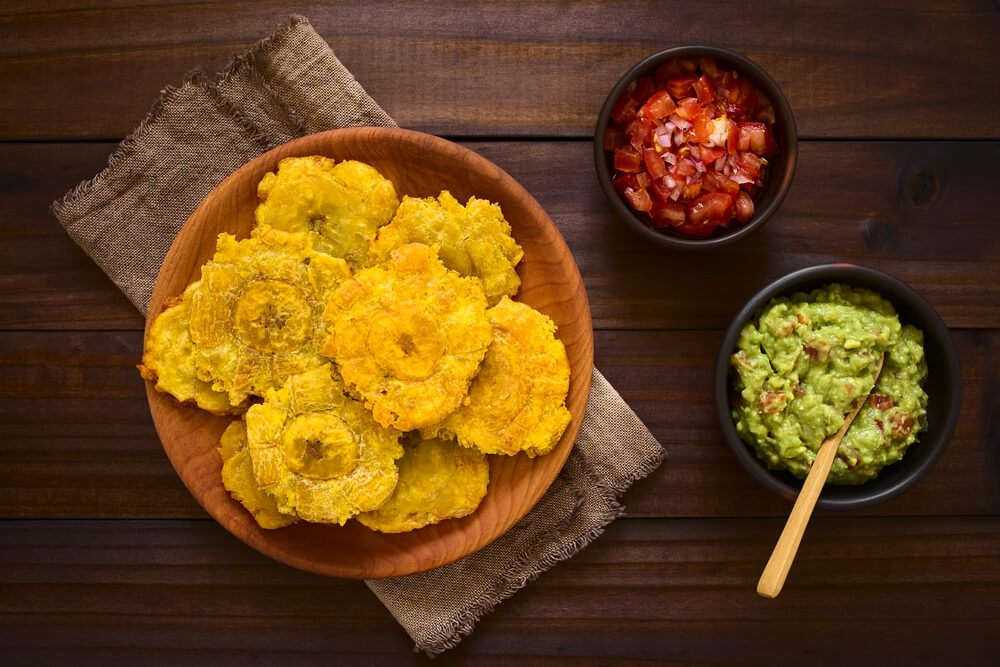Tostones with guacamole and tomato onion salad